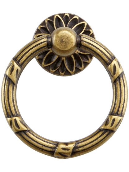 Ribbon and Reed Ring Pull With Flower Motif.